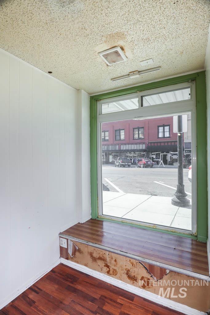 Detailed view of wood finished floors and a textured ceiling