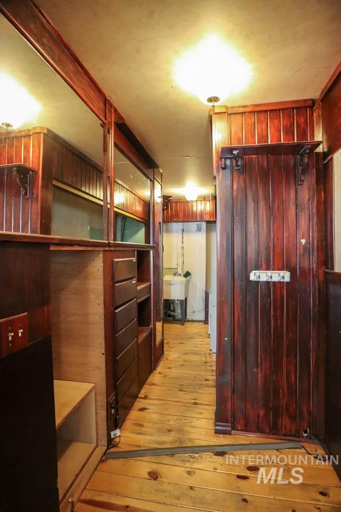 Spacious closet with light wood-type flooring and a sink