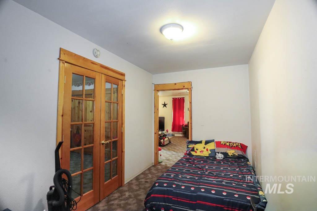 Bedroom with french doors and carpet