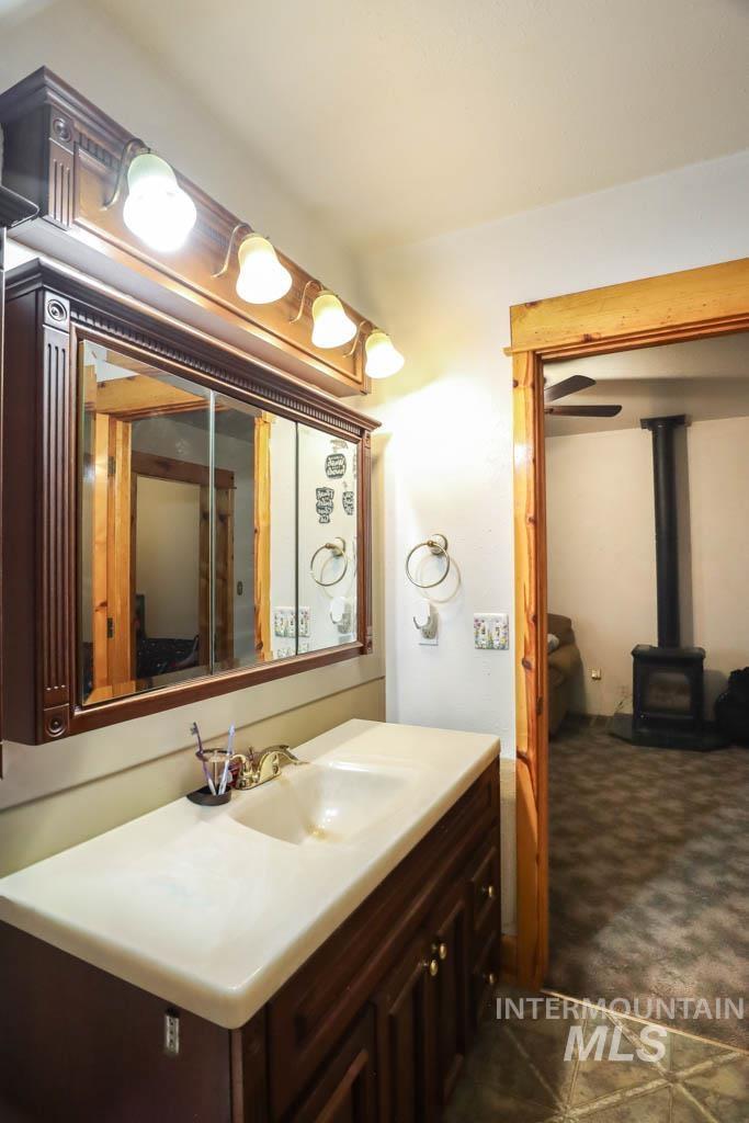 Bathroom with vanity and a wood stove