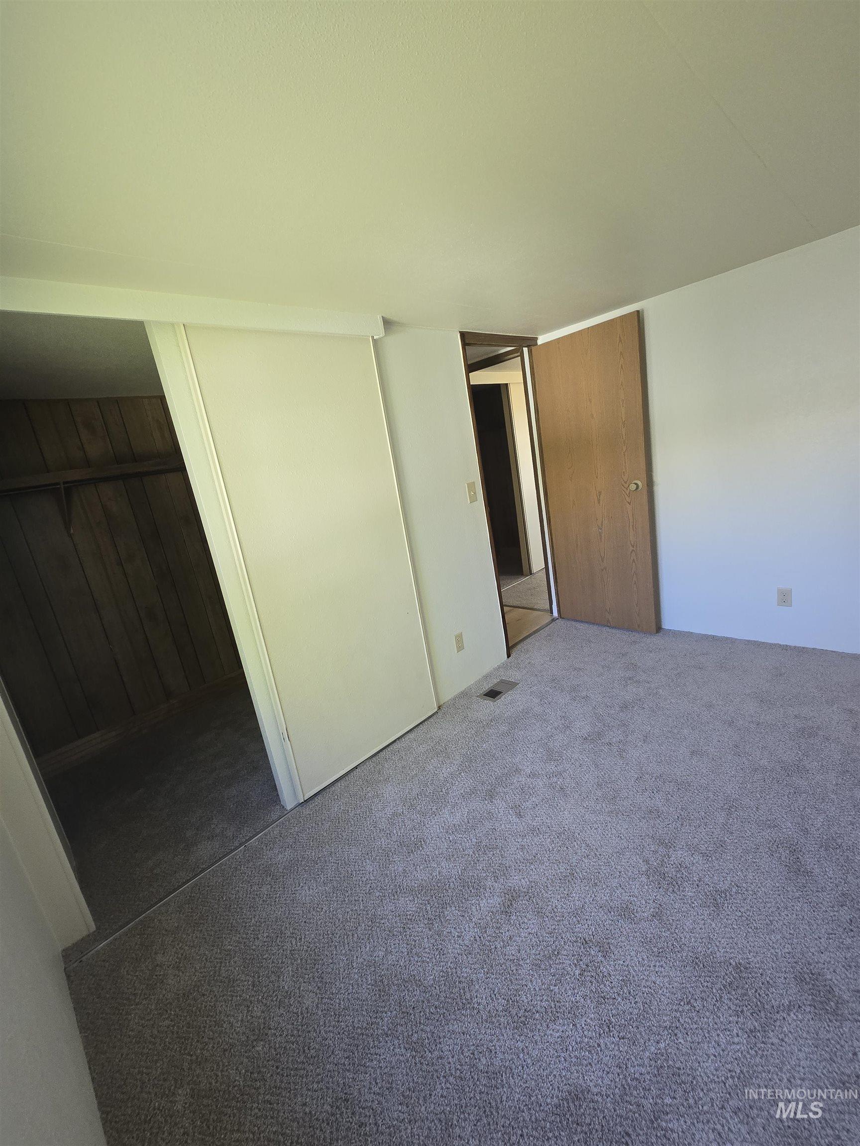 Unfurnished bedroom with carpet