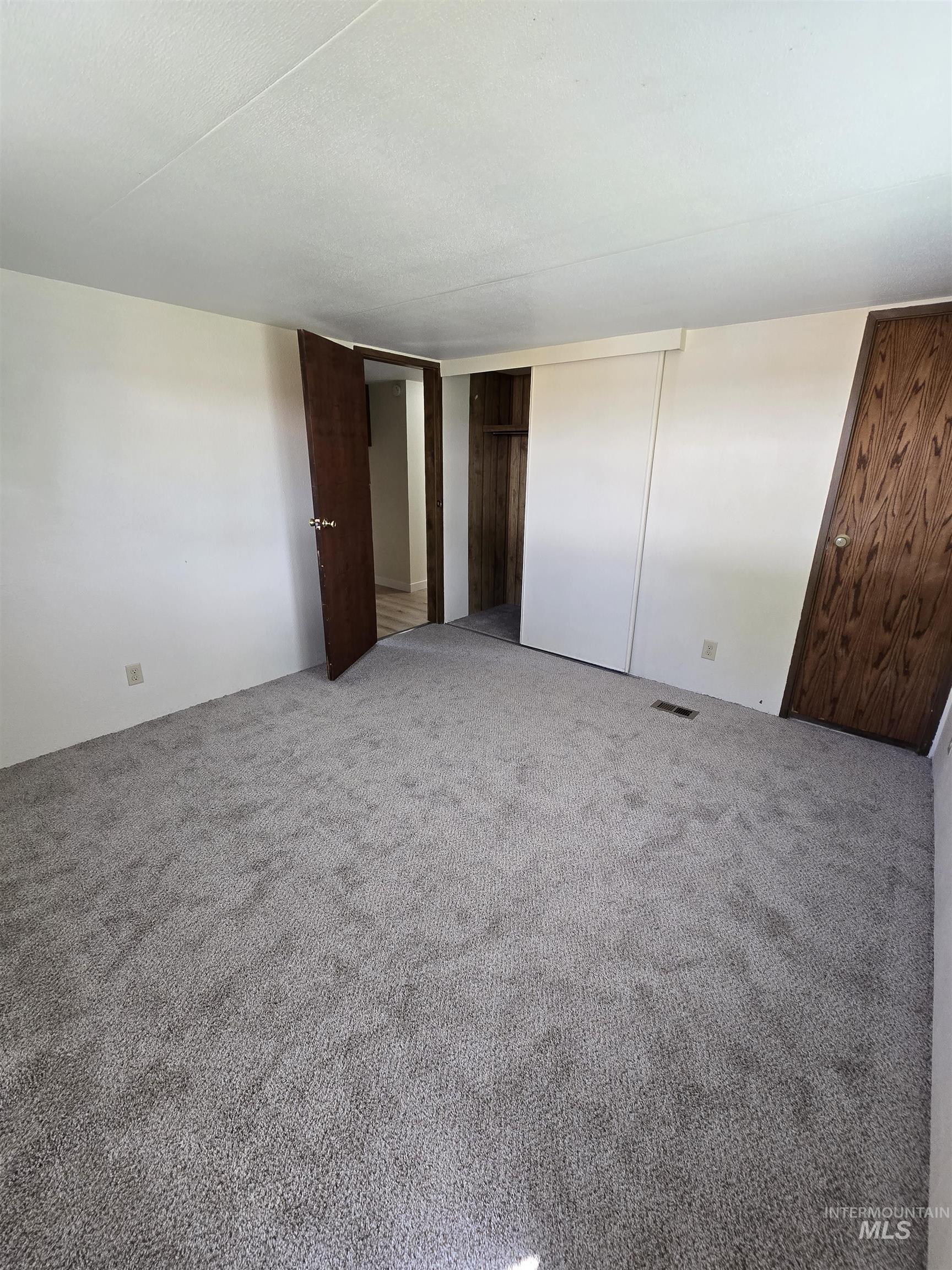 Unfurnished bedroom with carpet floors and a closet