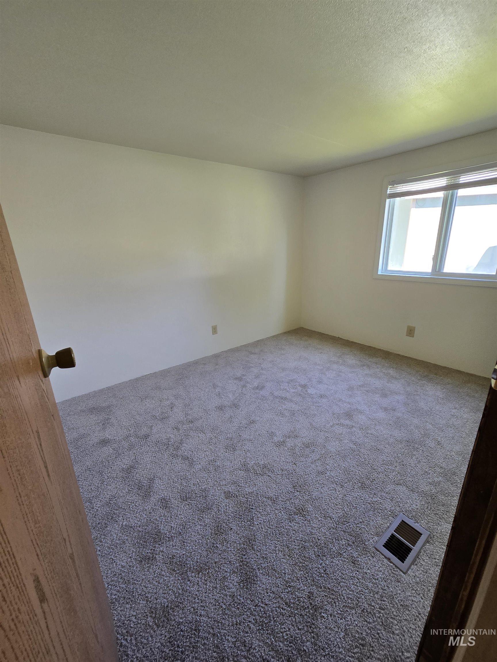 Empty room featuring carpet floors