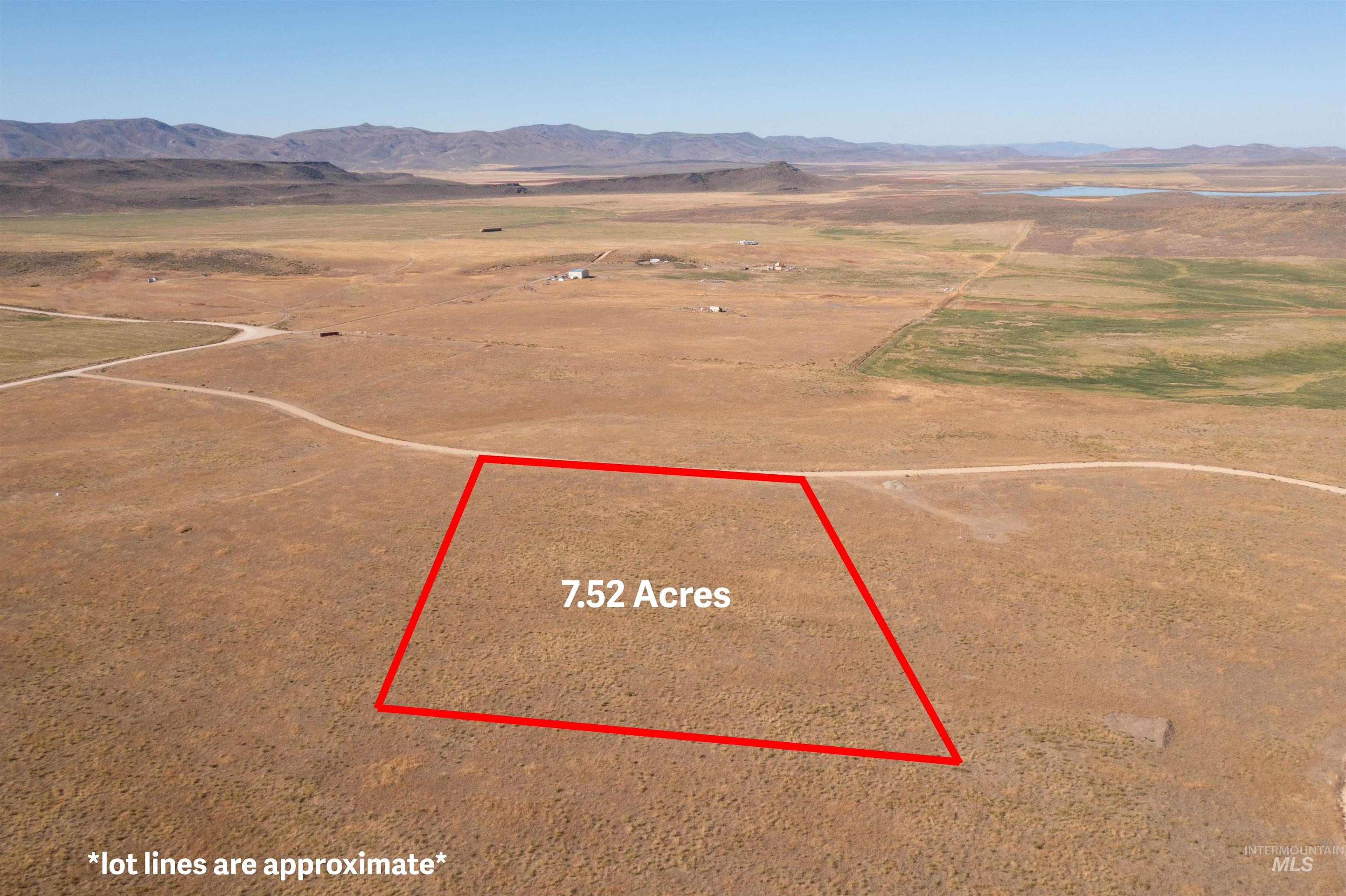 Aerial view of sparsely populated area featuring a mountain backdrop and property boundaries highlighted