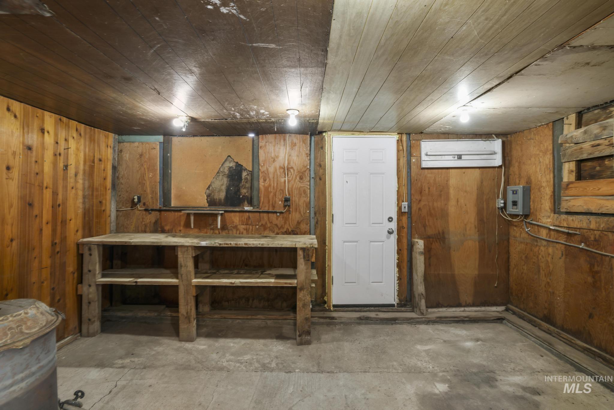 Finished below grade area featuring wood walls and wood ceiling