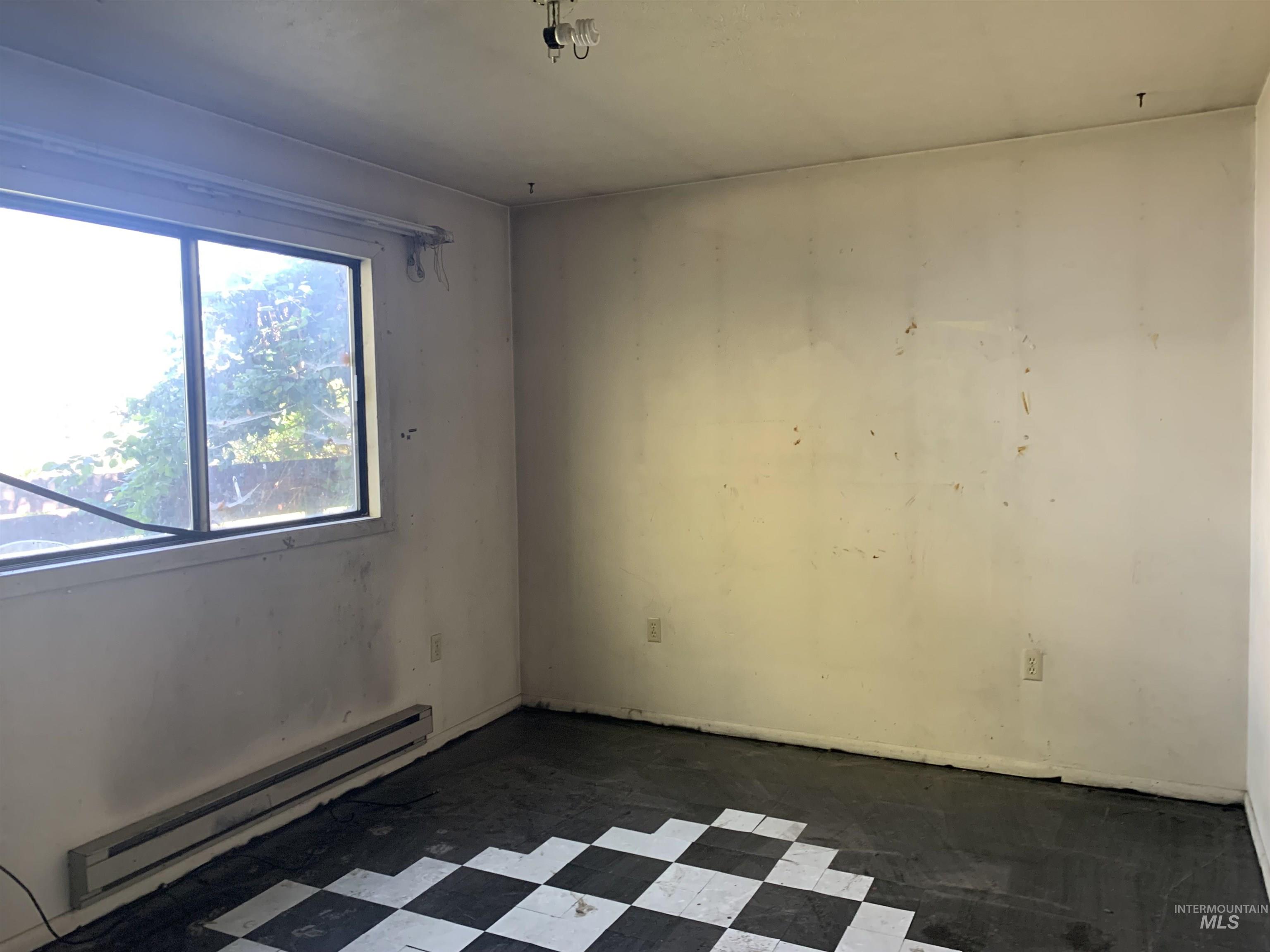 Unfurnished room with a baseboard radiator
