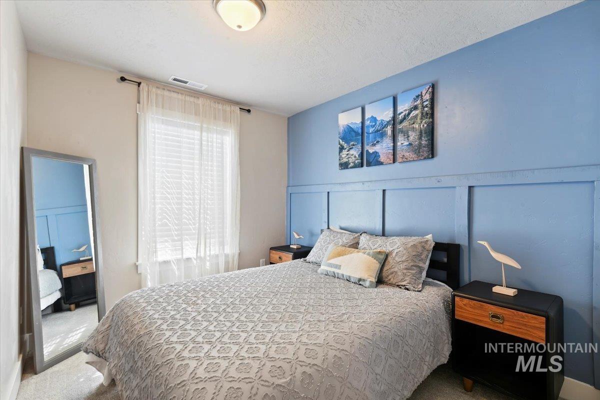 Carpeted bedroom with a textured ceiling