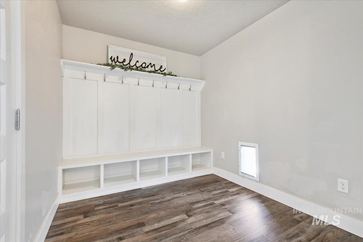 Mudroom featuring dark wood finished floors and a textured ceiling