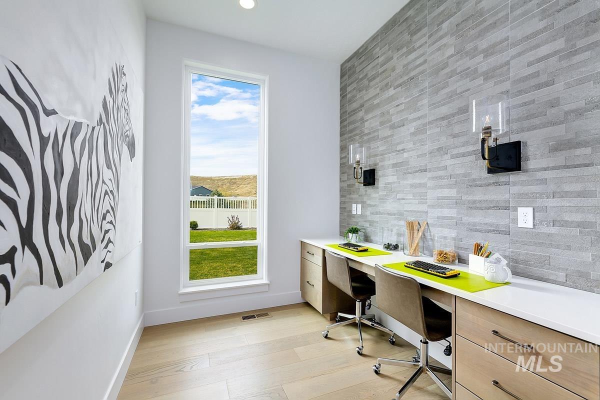 Office space featuring light wood-type flooring and recessed lighting