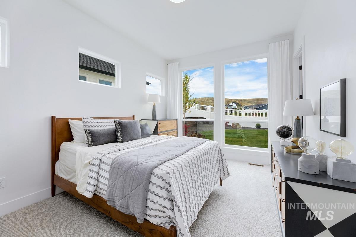 Bedroom with light colored carpet