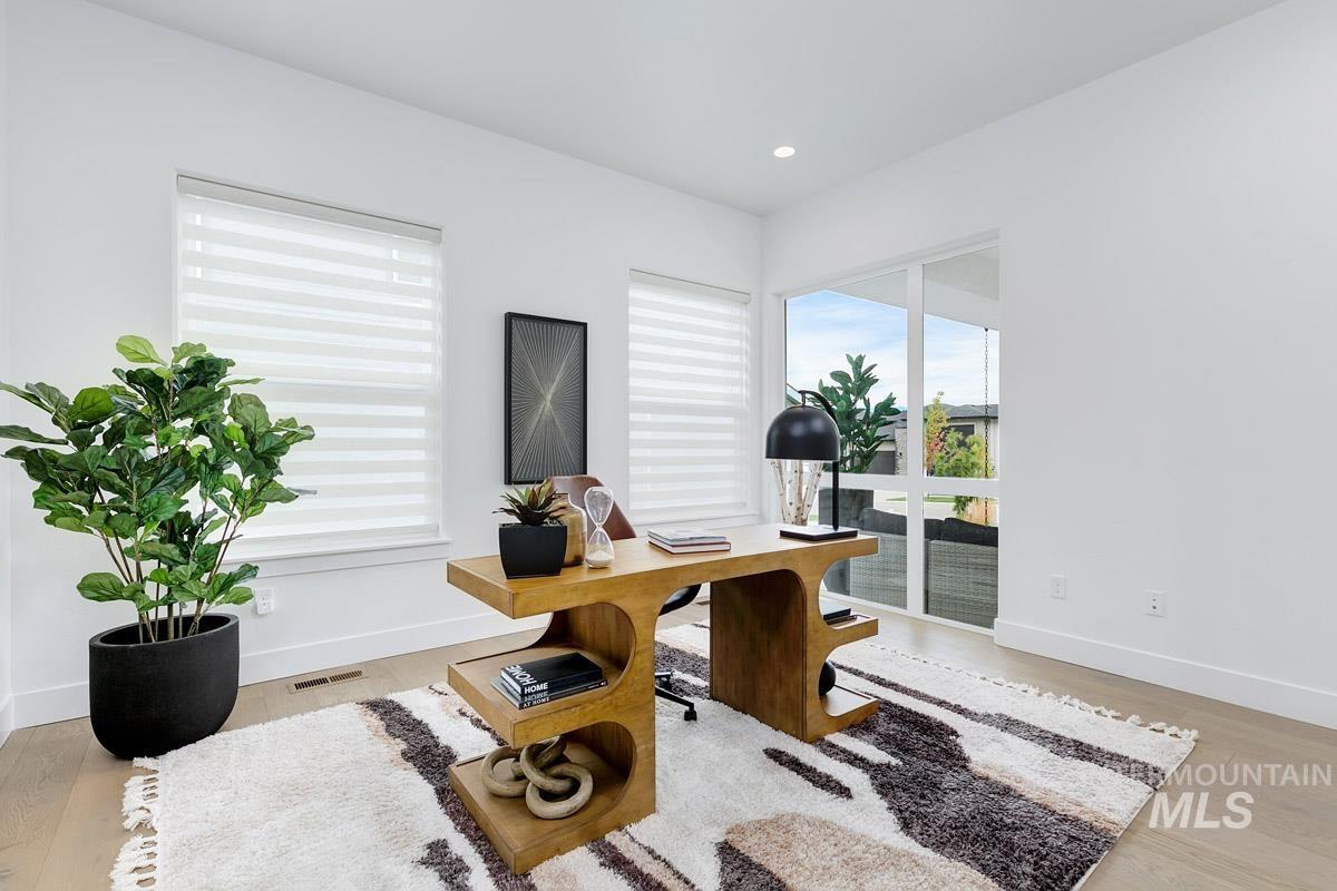 Home office featuring light wood-style flooring and recessed lighting