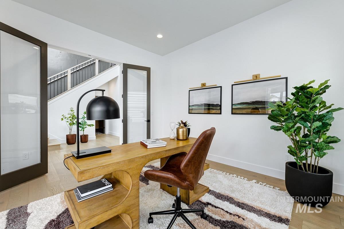 Office featuring light wood finished floors and recessed lighting