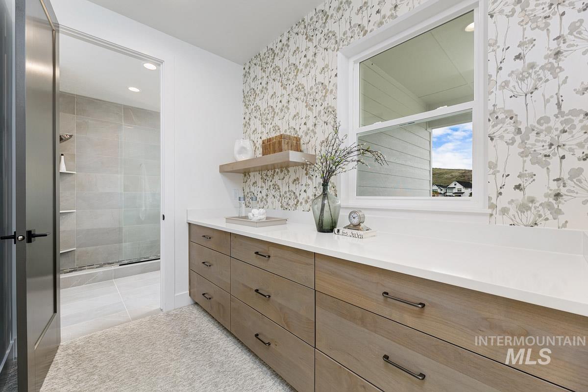 Bathroom with vanity, a stall shower, wallpapered walls, and recessed lighting