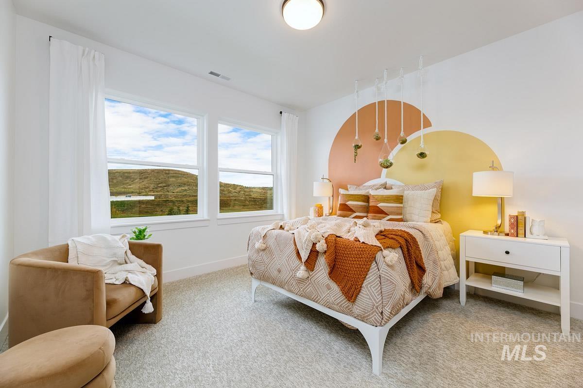 Carpeted bedroom featuring baseboards