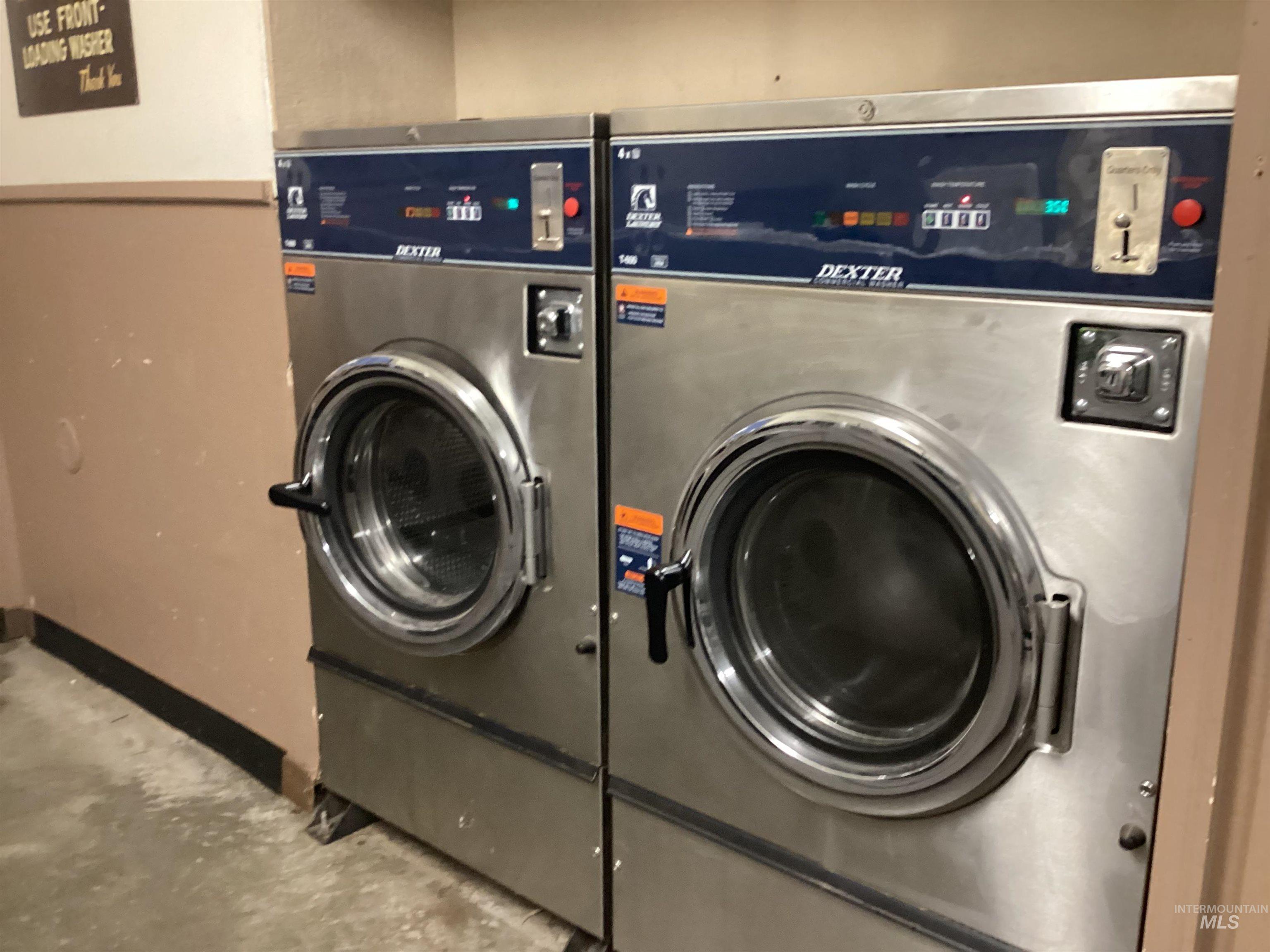 Laundry room featuring washer / clothes dryer and concrete flooring
