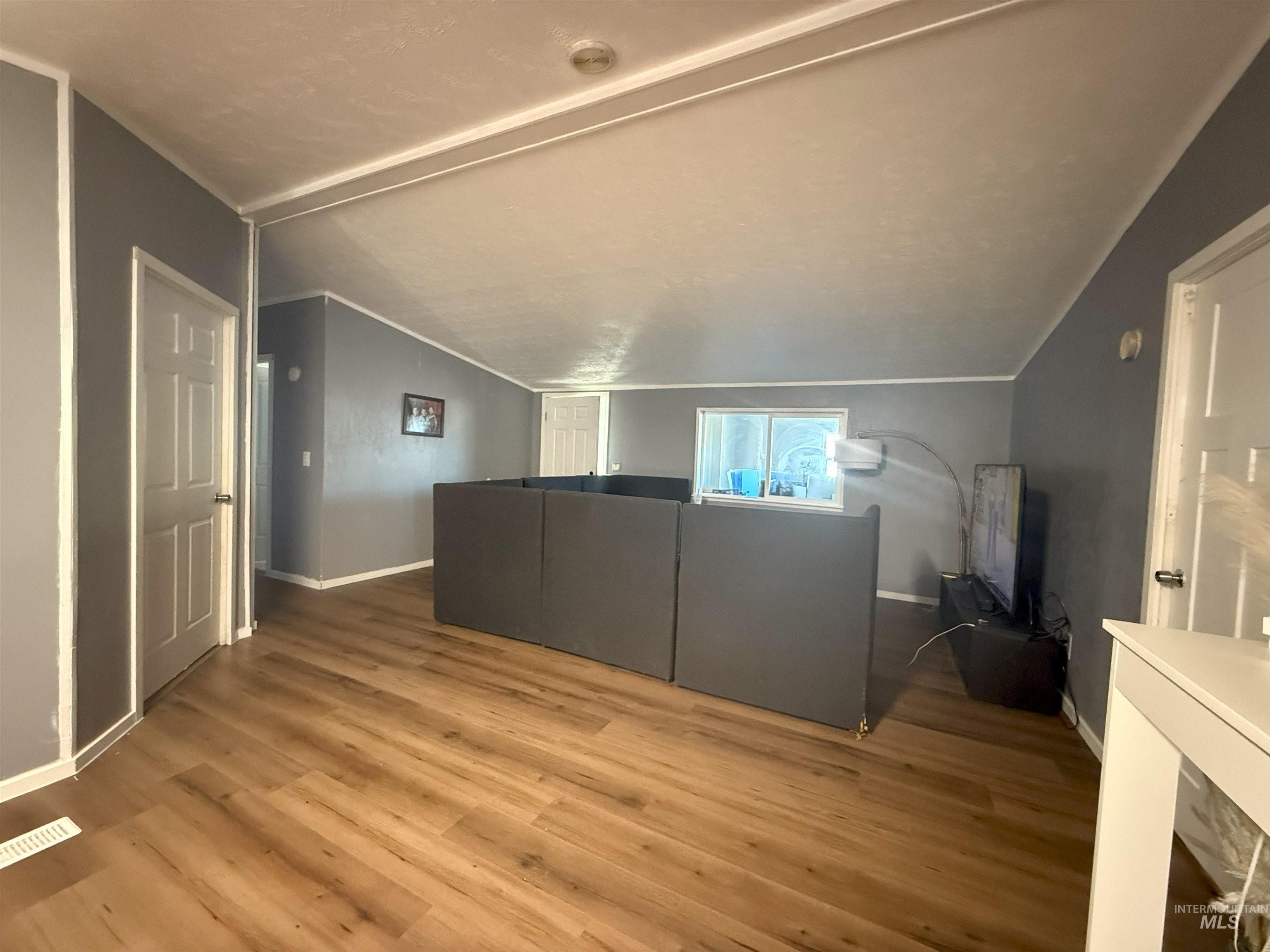 Bonus room with wood finished floors and lofted ceiling