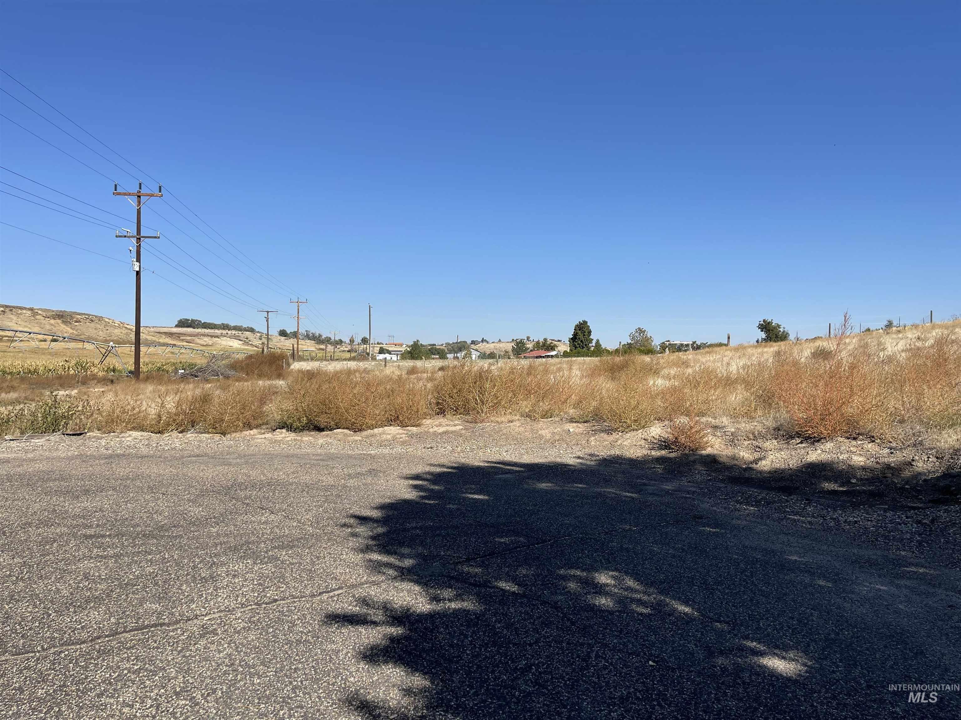 View of asphalt road featuring a rural view