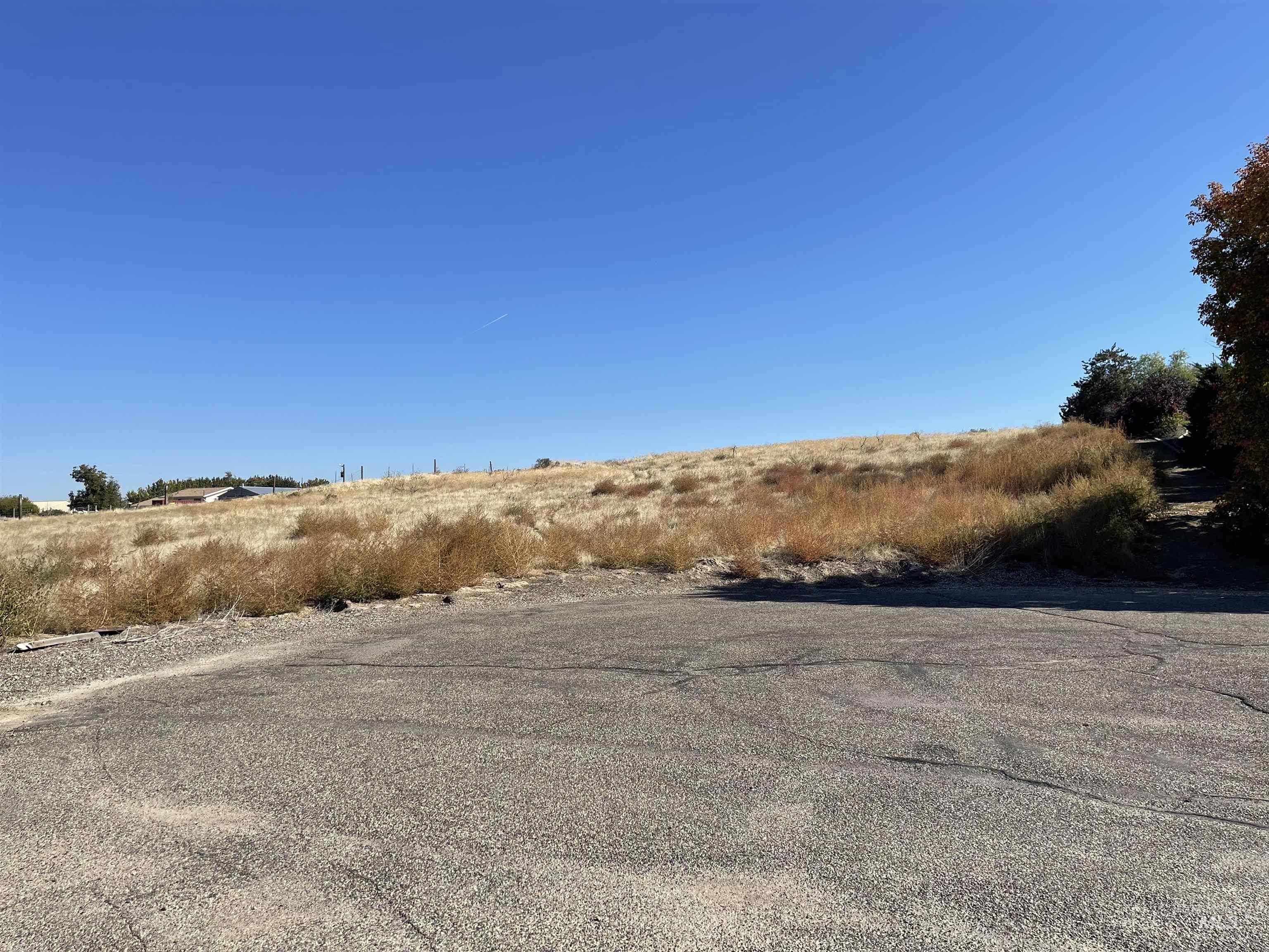 View of asphalt road featuring a rural view