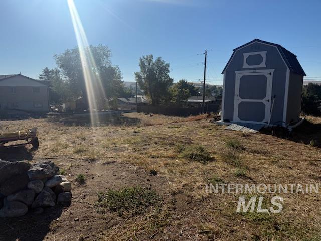 View of yard with a storage unit