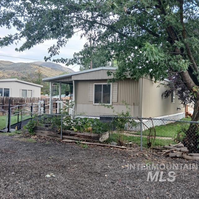 View of property exterior featuring a fenced front yard