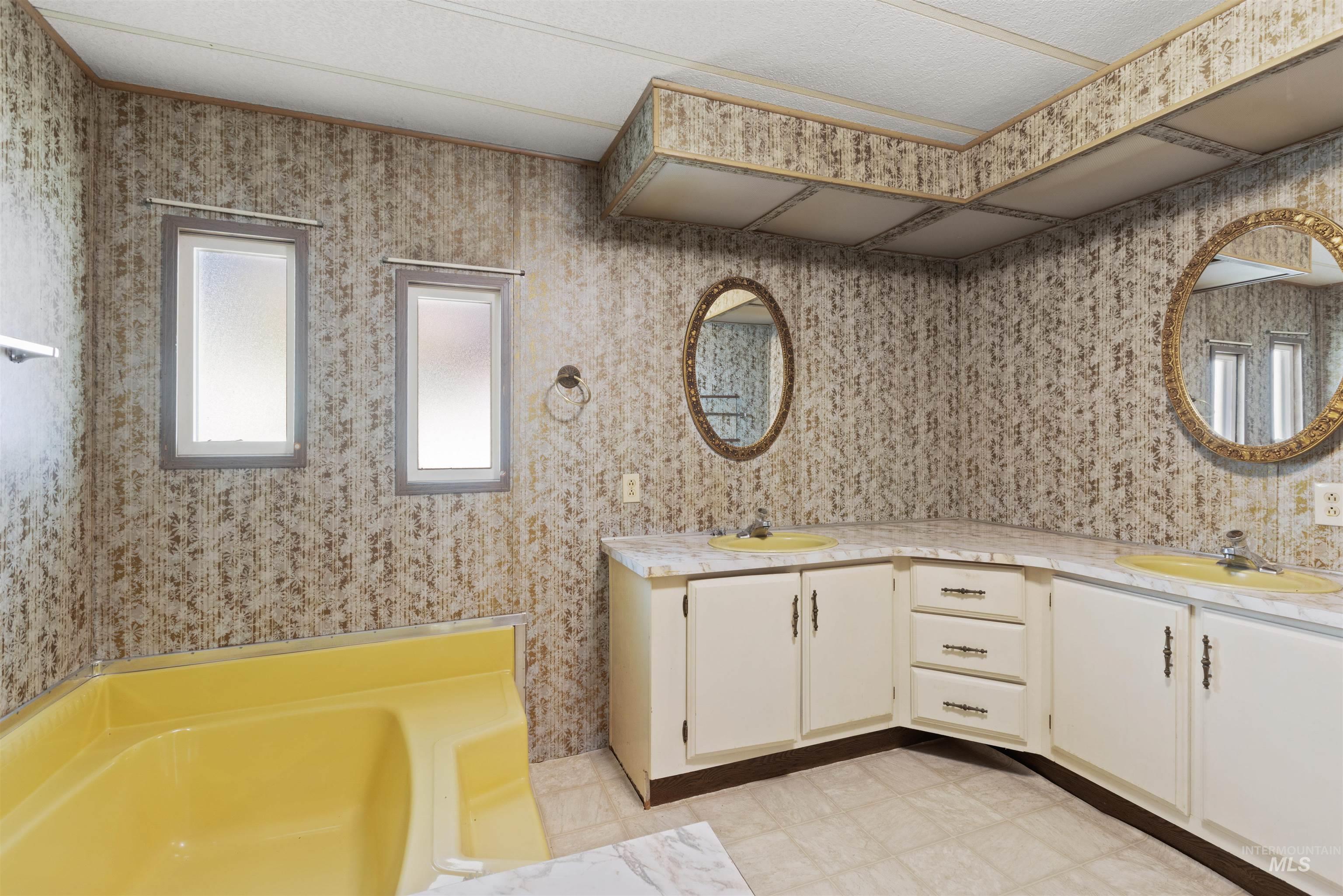 Full bathroom with double vanity and a garden tub