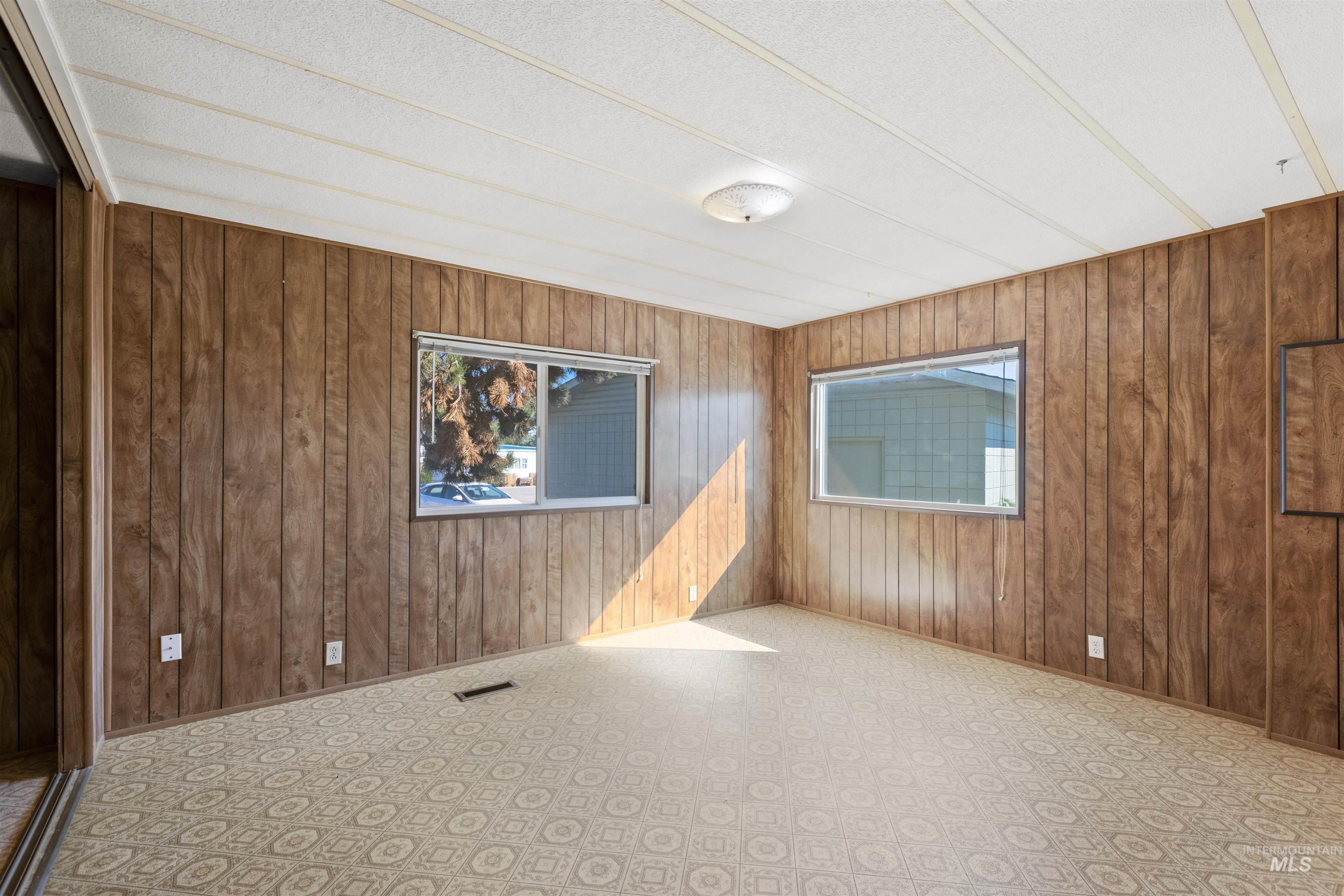 Empty room featuring wooden walls