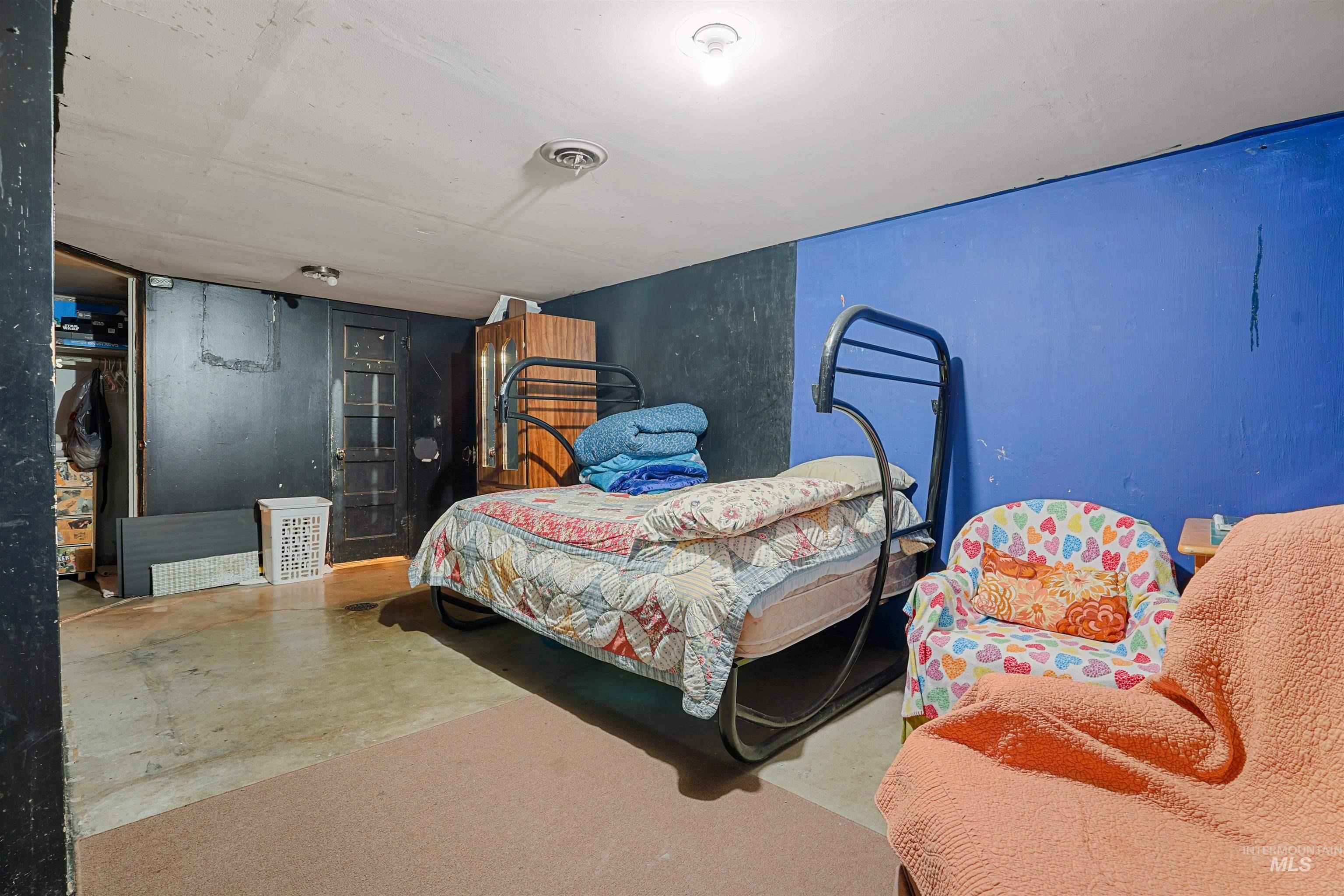 Bedroom featuring concrete flooring
