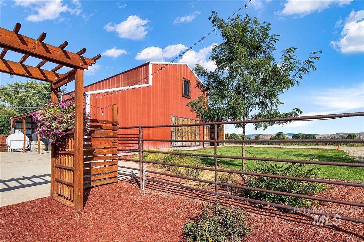 View of yard featuring an outdoor structure, a pergola, and an exterior structure