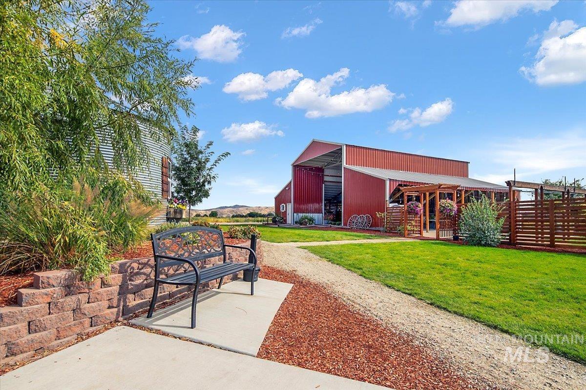 View of property's community featuring a yard, an outbuilding, and a pole building