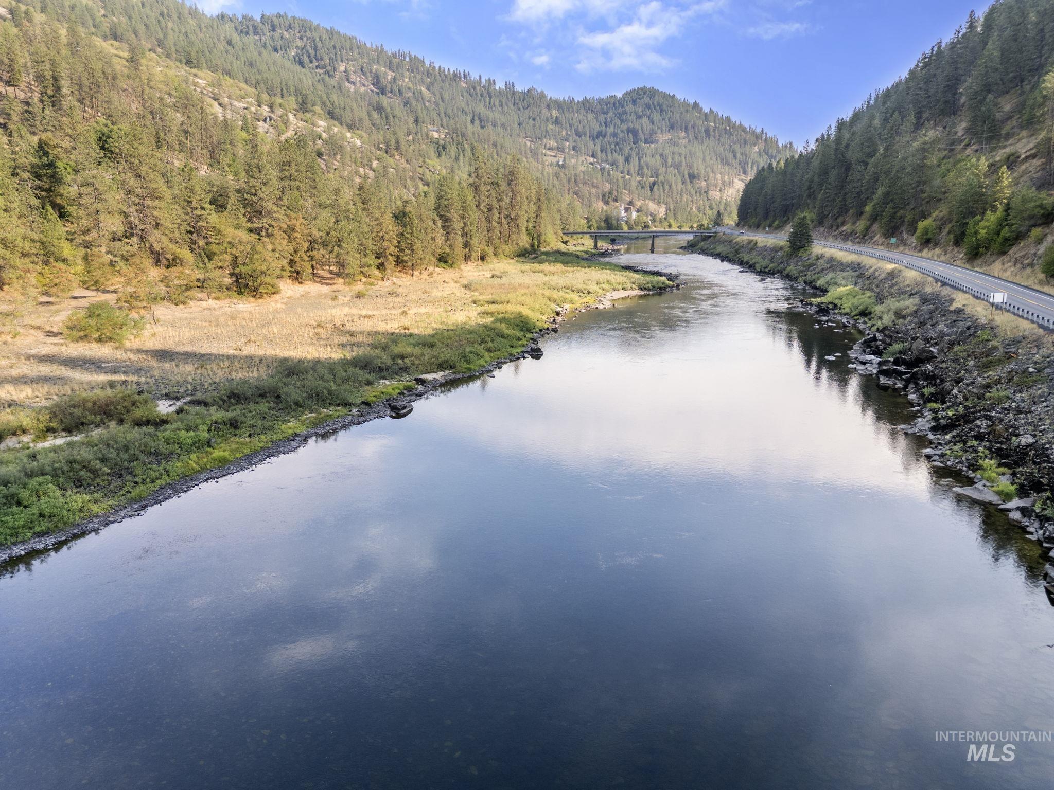 Water view featuring a heavily wooded area and mountains
