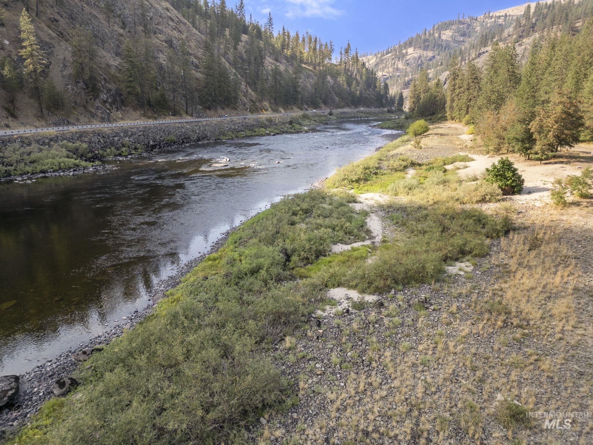 Water view with a forest and mountains