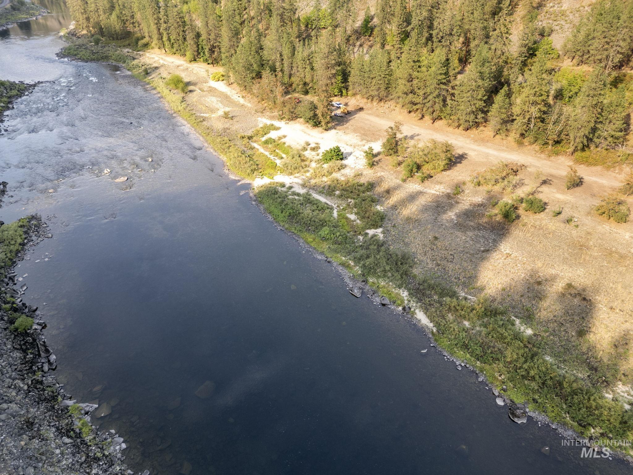Aerial view of property and surrounding area with a nearby body of water