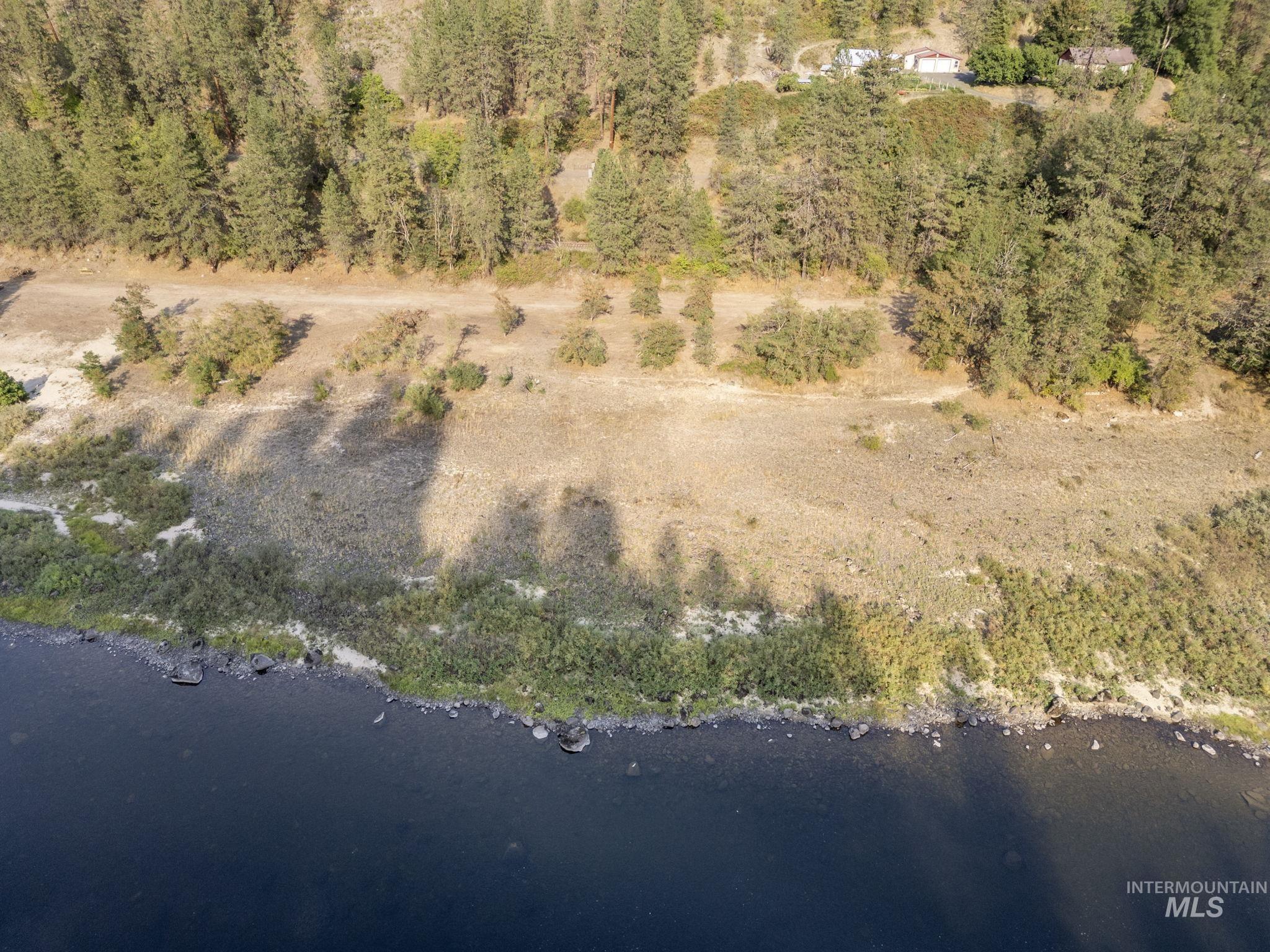 Aerial view of property's location featuring a large body of water