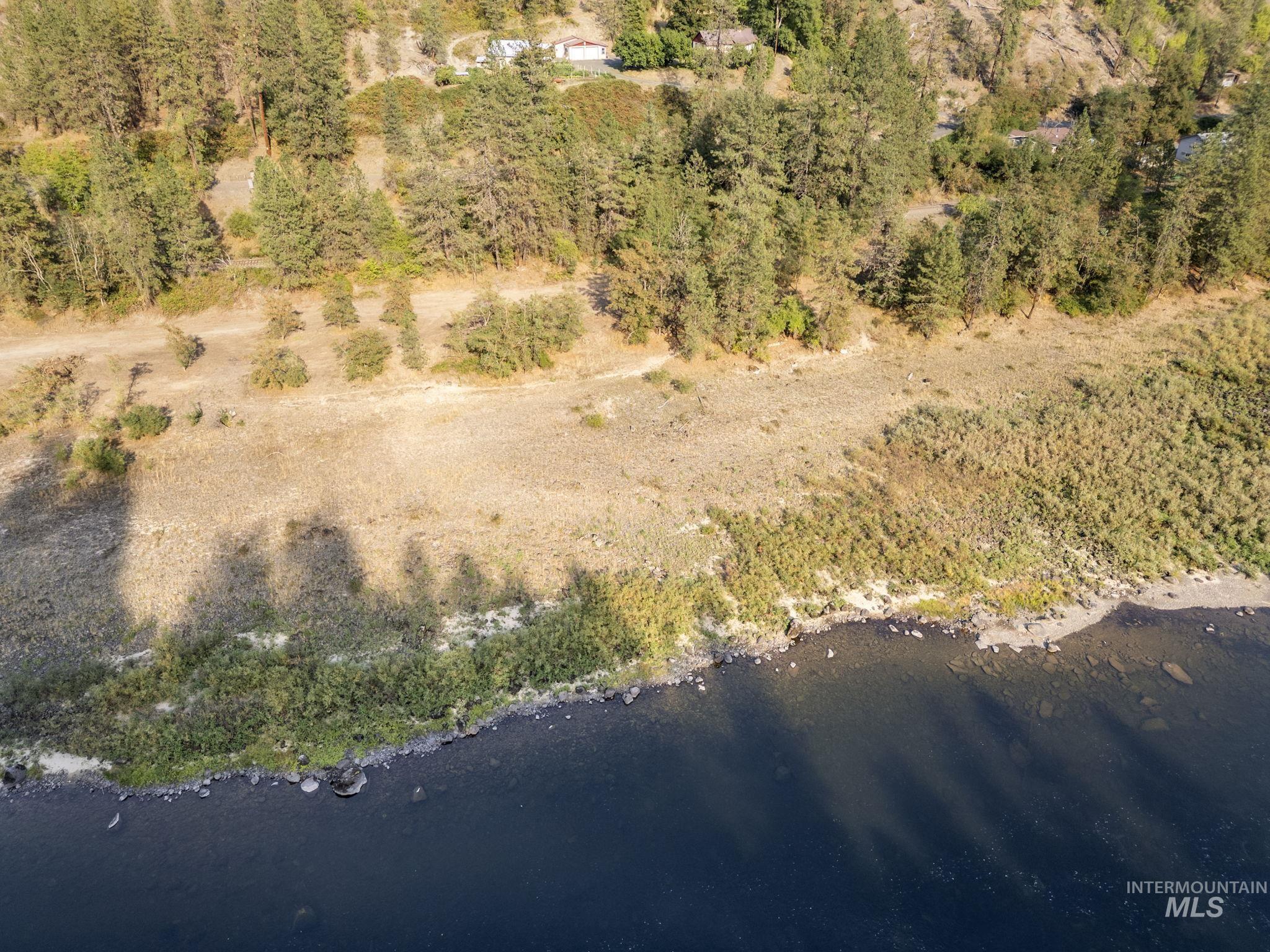 Aerial view of property and surrounding area featuring a nearby body of water