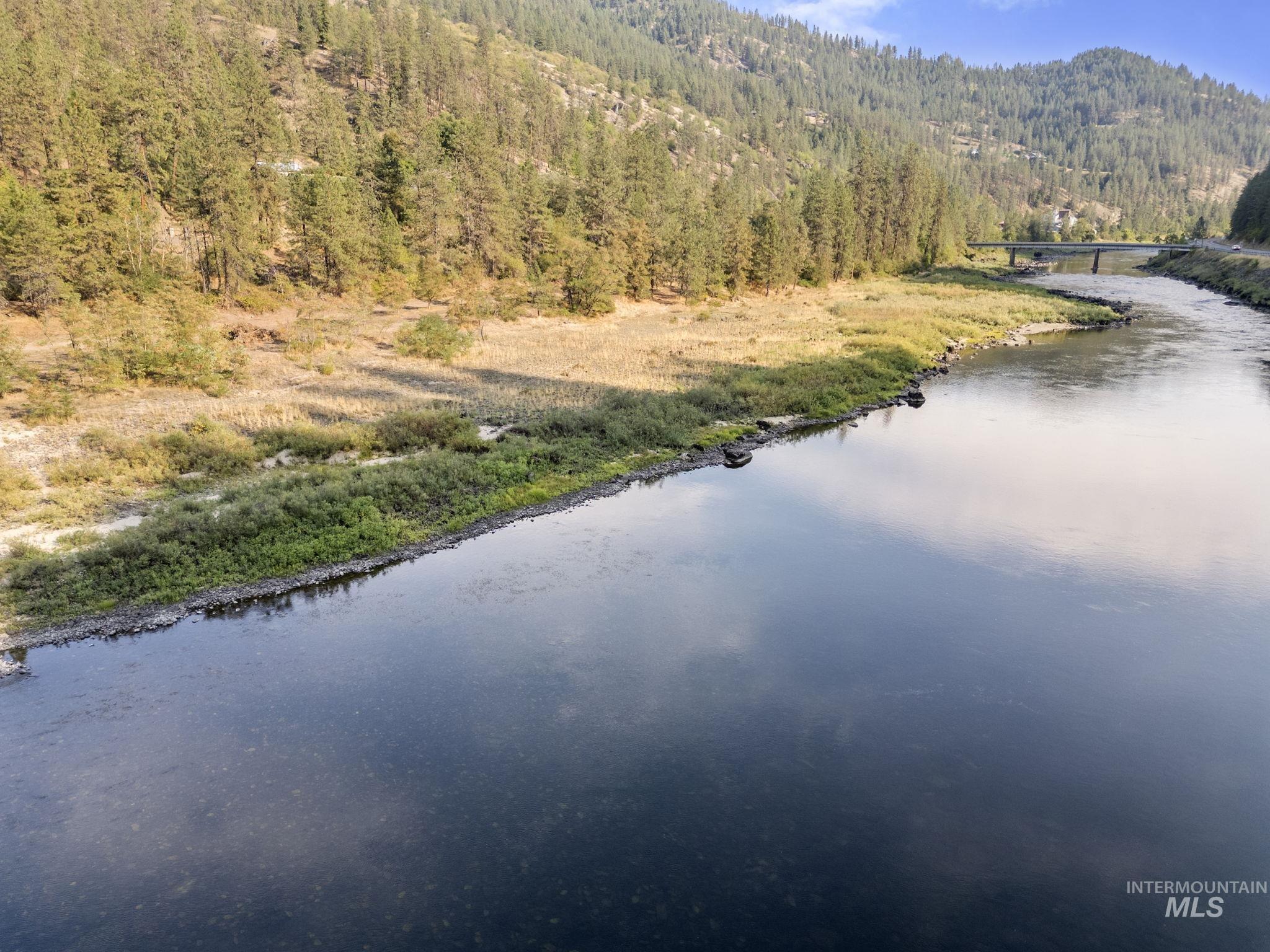 Water view with a heavily wooded area