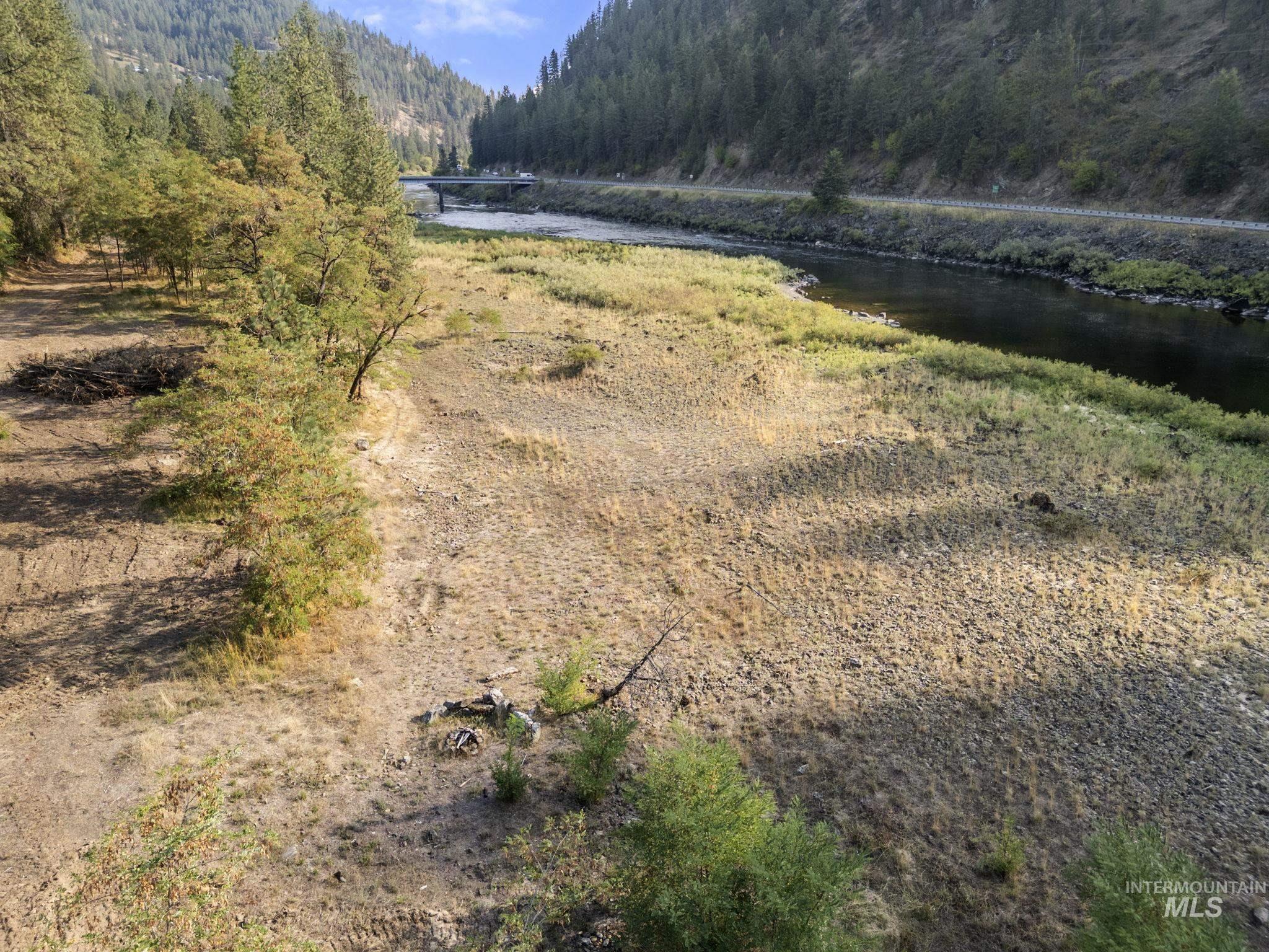 Exterior space with a large body of water and a heavily wooded area