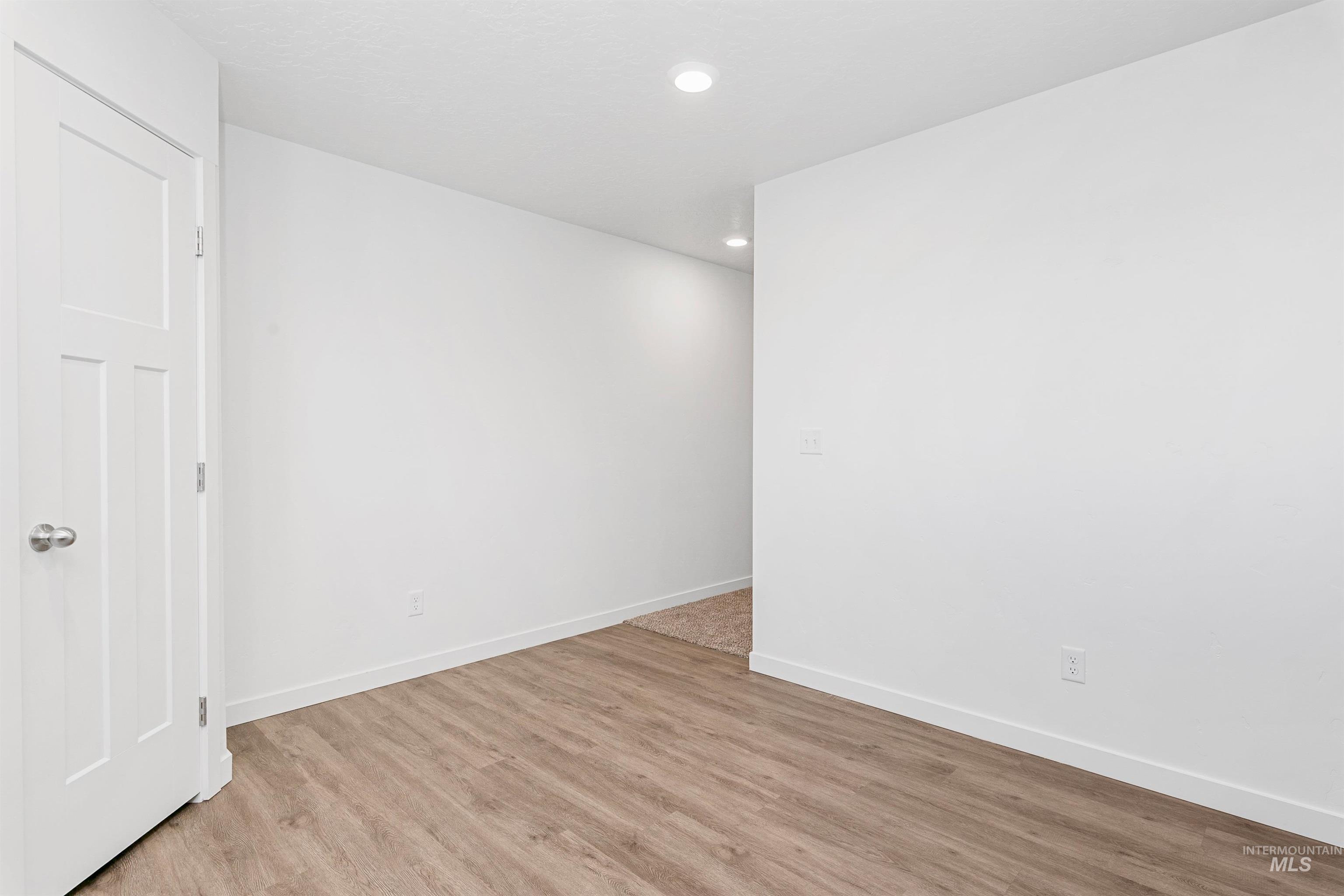 Spare room featuring recessed lighting and light wood-type flooring