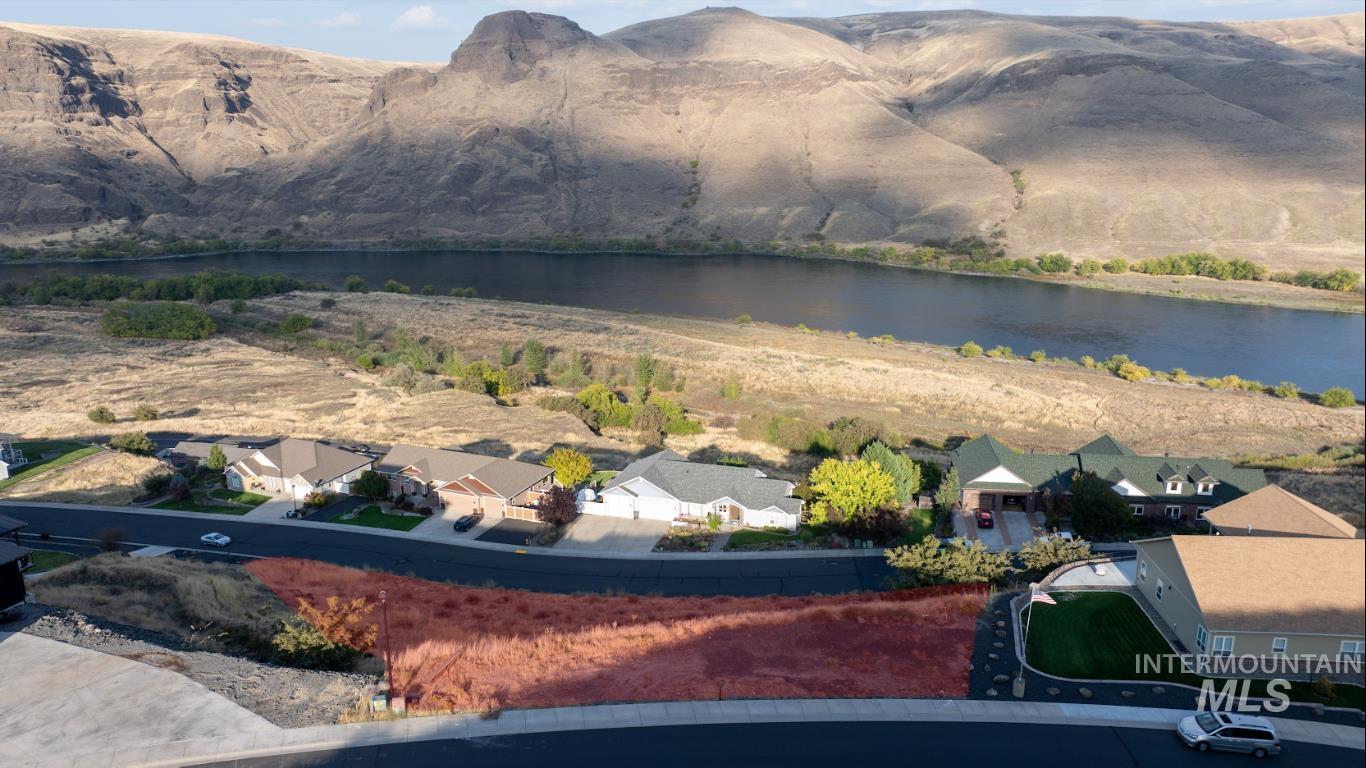 Aerial perspective of suburban area featuring a water and mountain view