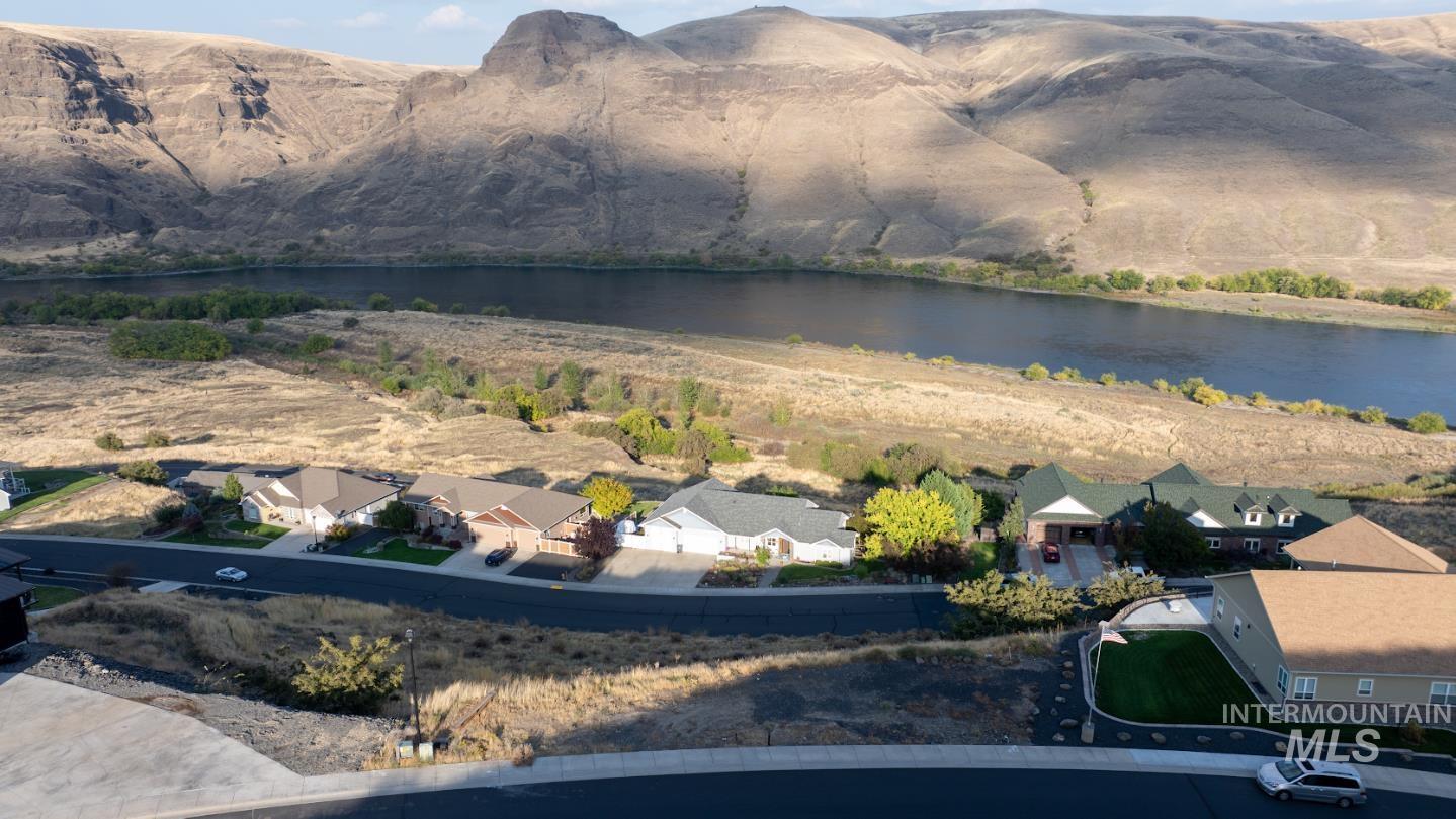 Aerial perspective of suburban area featuring a water and mountain view