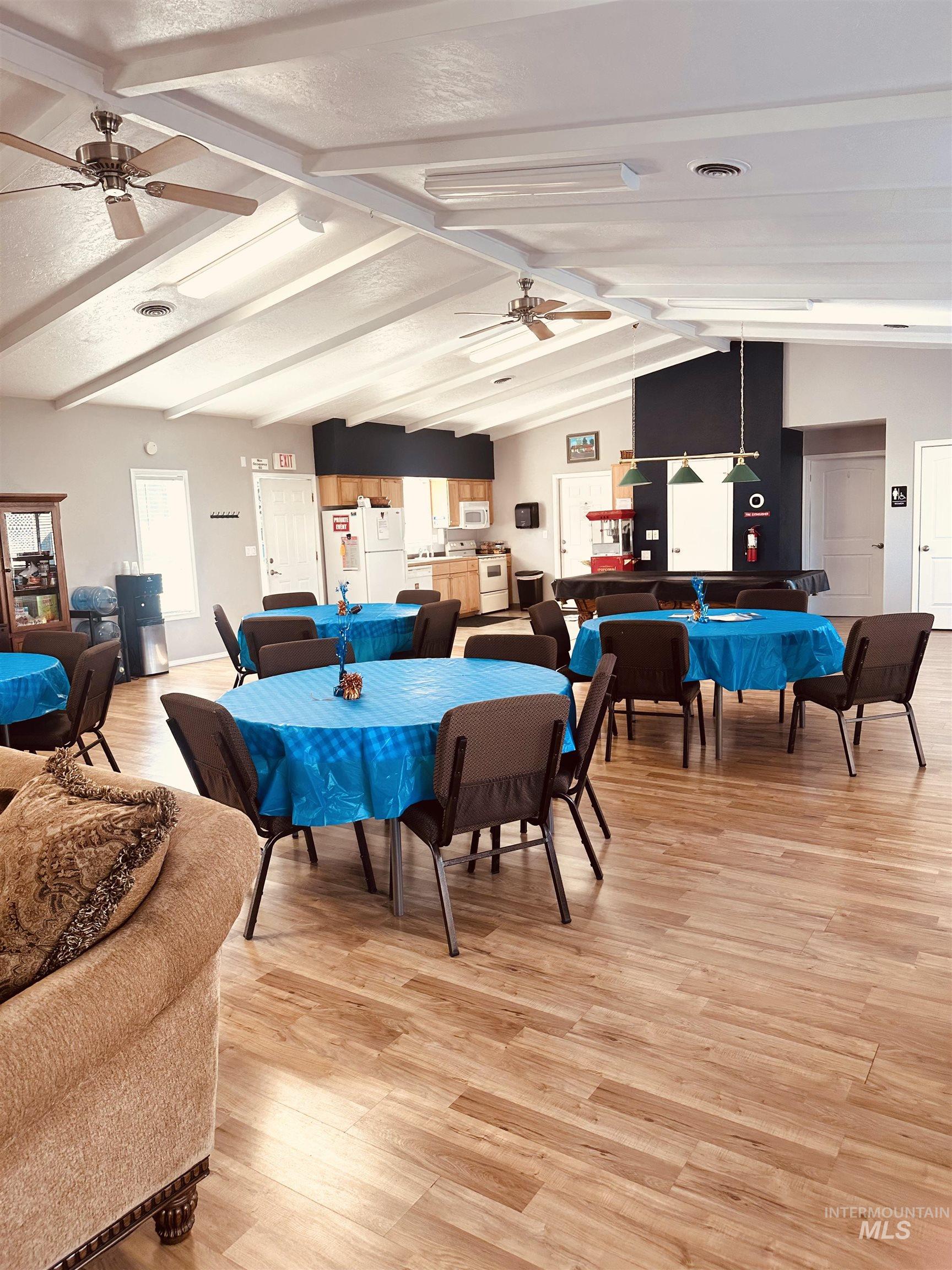Dining space featuring light wood-type flooring, ceiling fan, and a textured ceiling