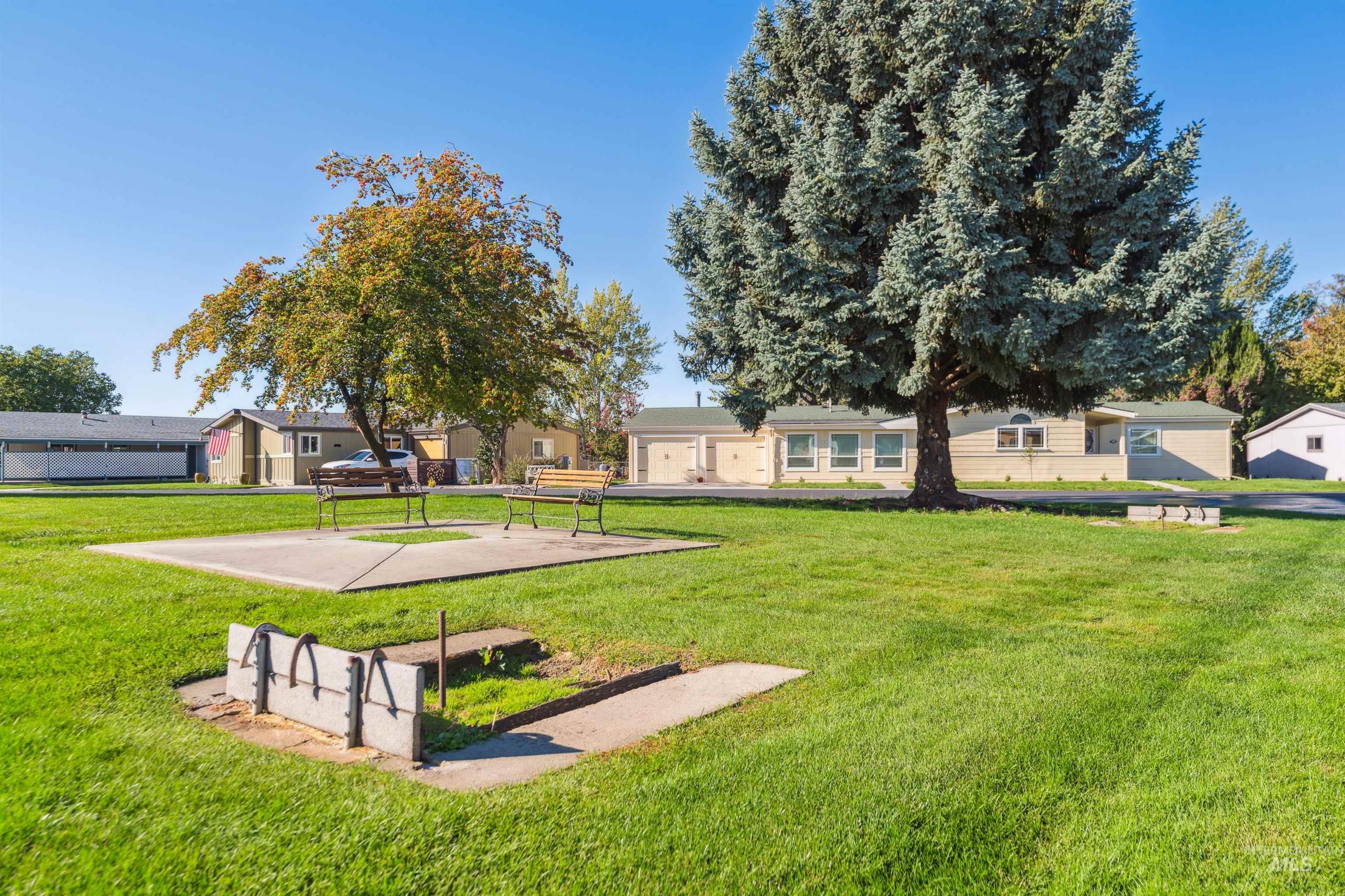 Surrounding community with a yard and a patio