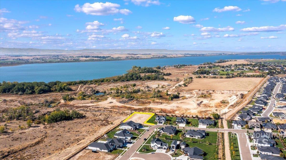 Aerial view of property's location featuring nearby suburban area and a large body of water