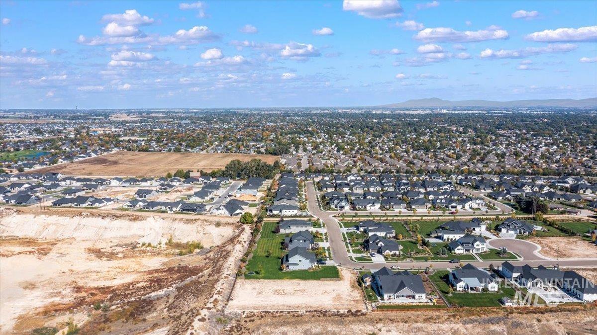 Aerial view of property's location featuring nearby suburban area and a mountain backdrop