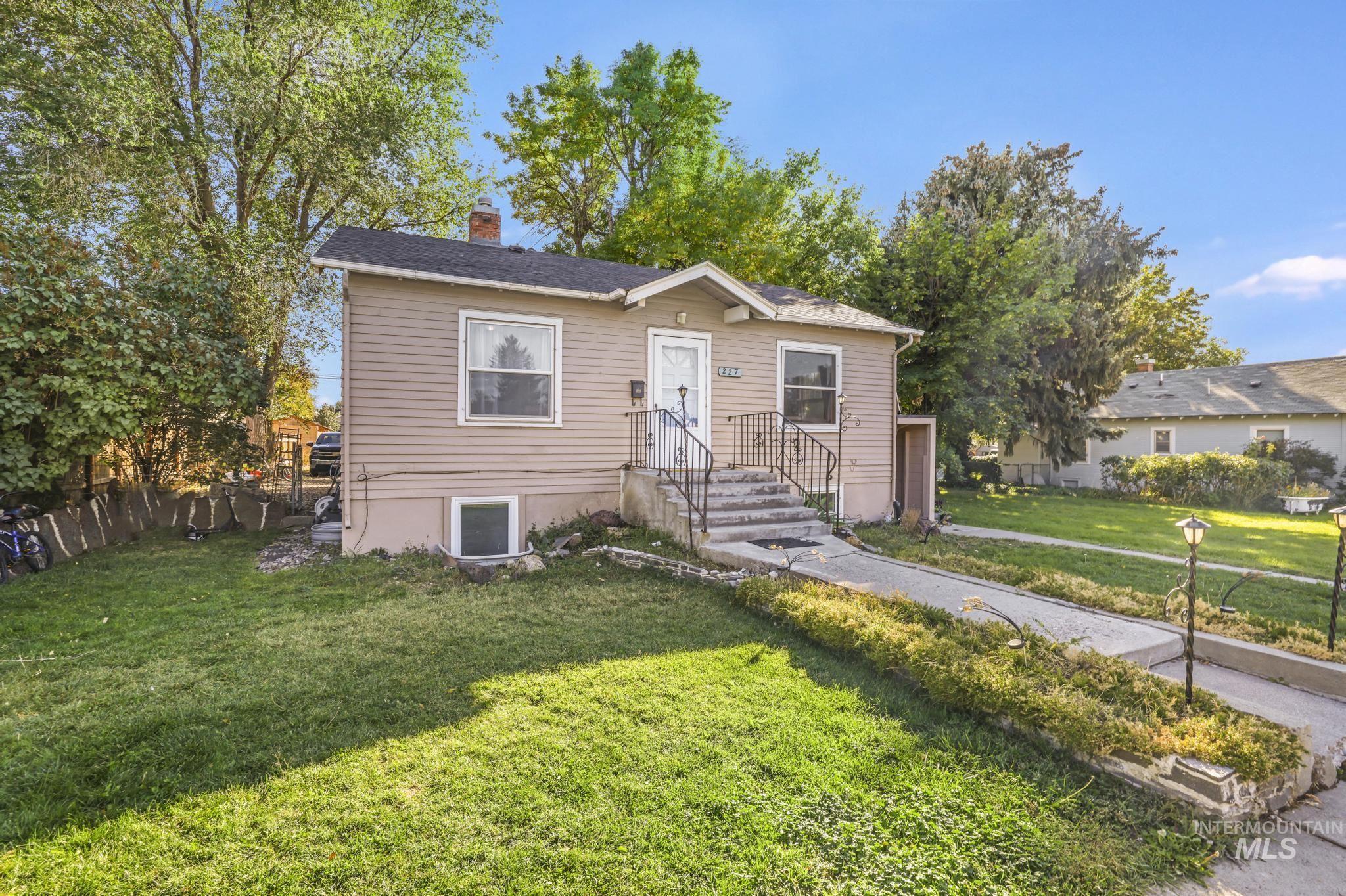 Bungalow with a front lawn and a chimney
