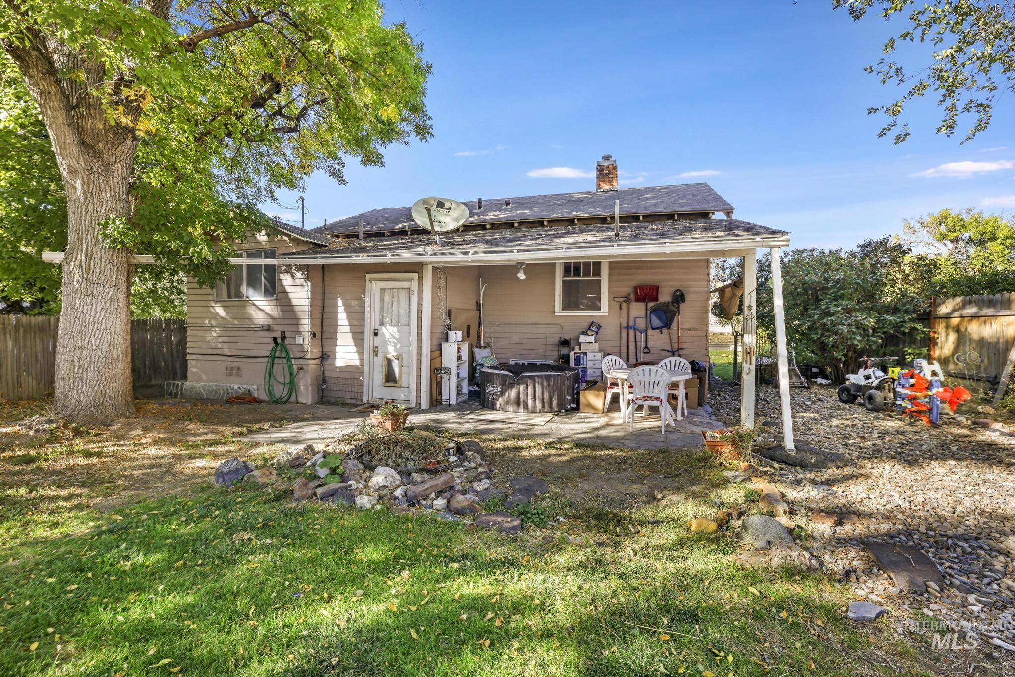 Back of property featuring a chimney, crawl space, a patio area, and a shingled roof