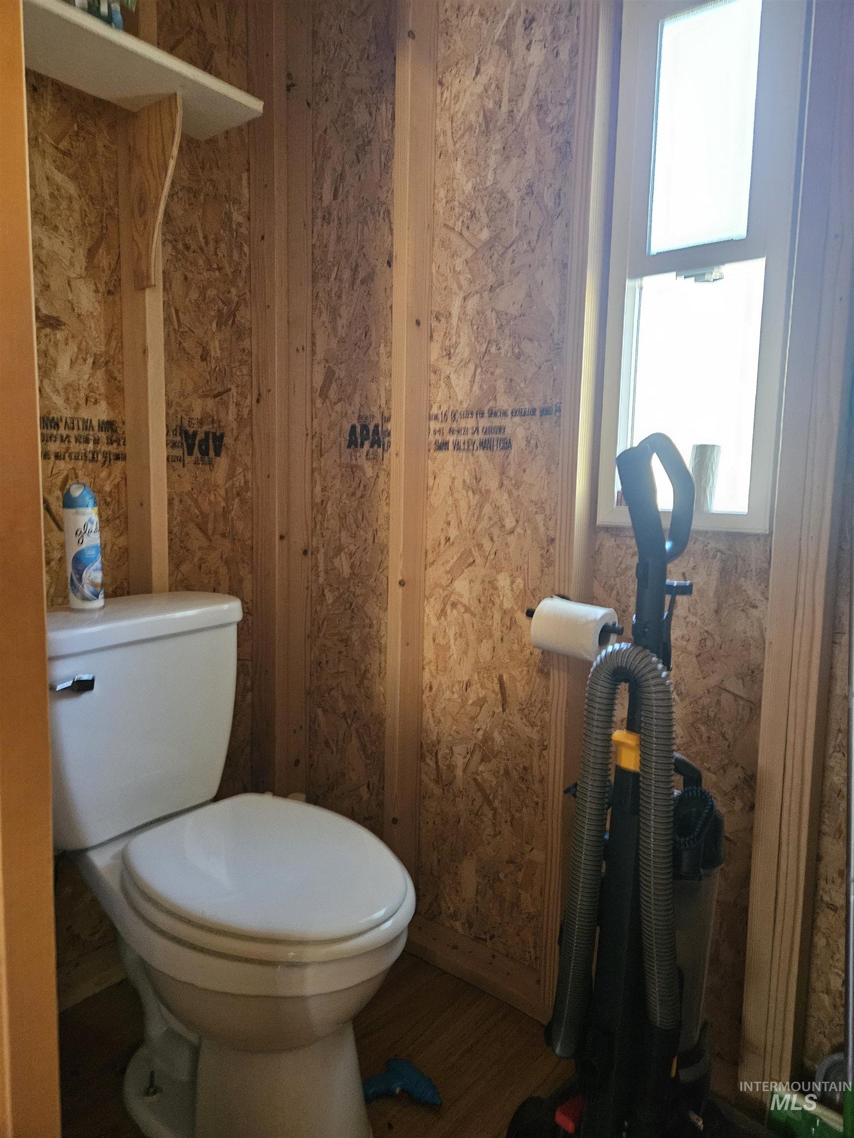 Bathroom featuring toilet and wood finished floors