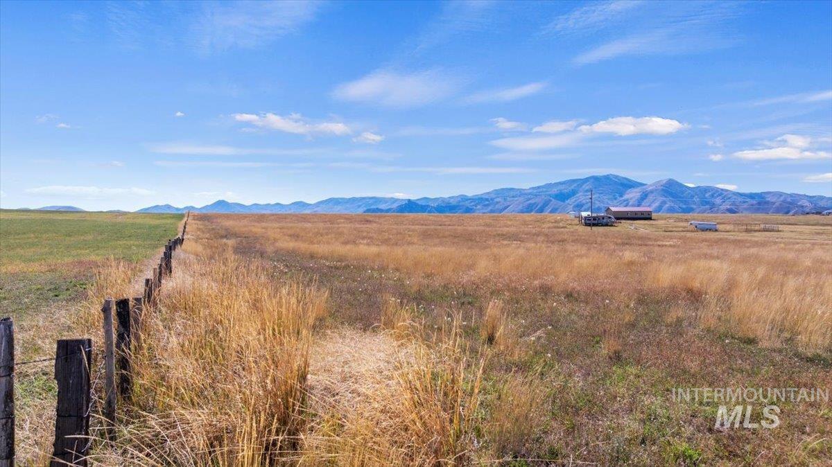 View of mountain backdrop featuring rural landscape