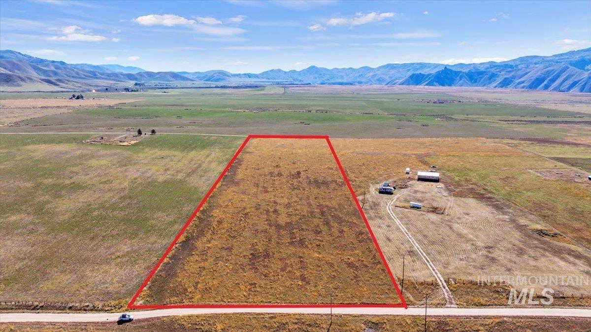 View of rural area with a mountainous background and property parcel outlined