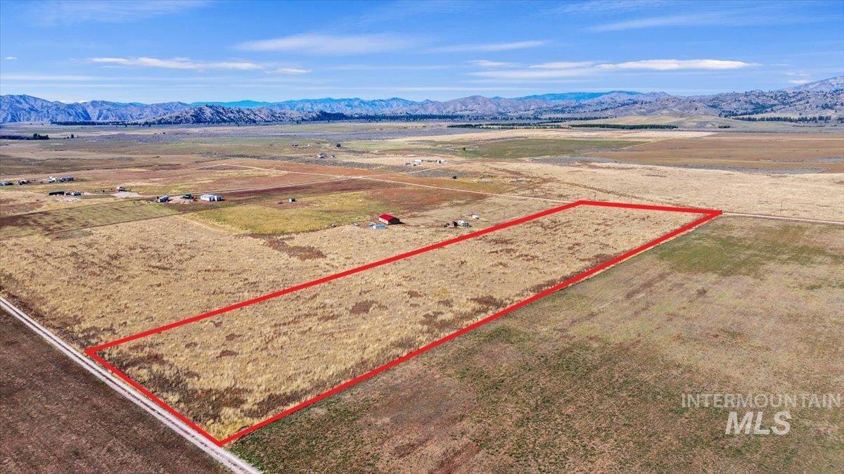 View of rural area with a mountain backdrop and property parcel outlined