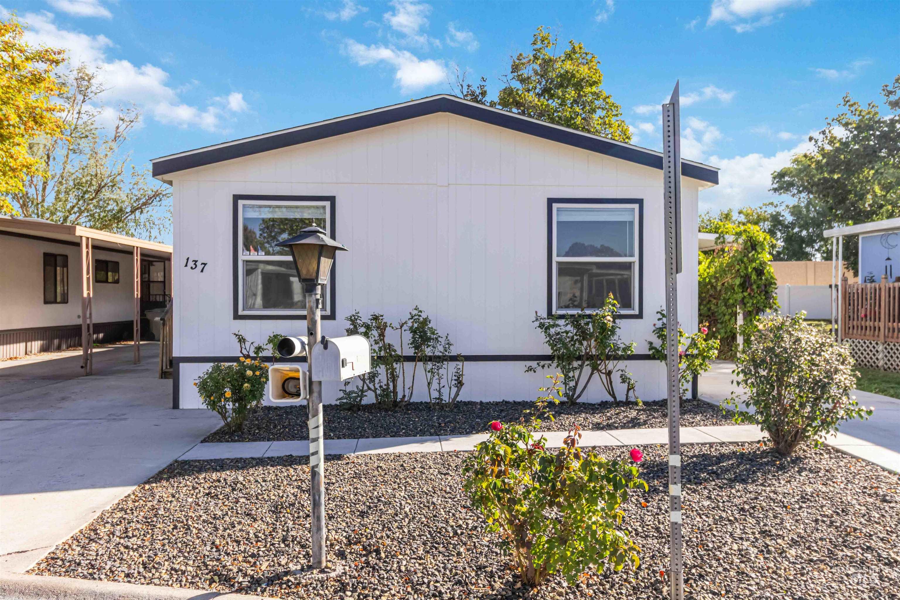 View of front of home featuring a carport and concrete driveway